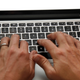 Photo: AP, an unrelated married person types upon a laptop.